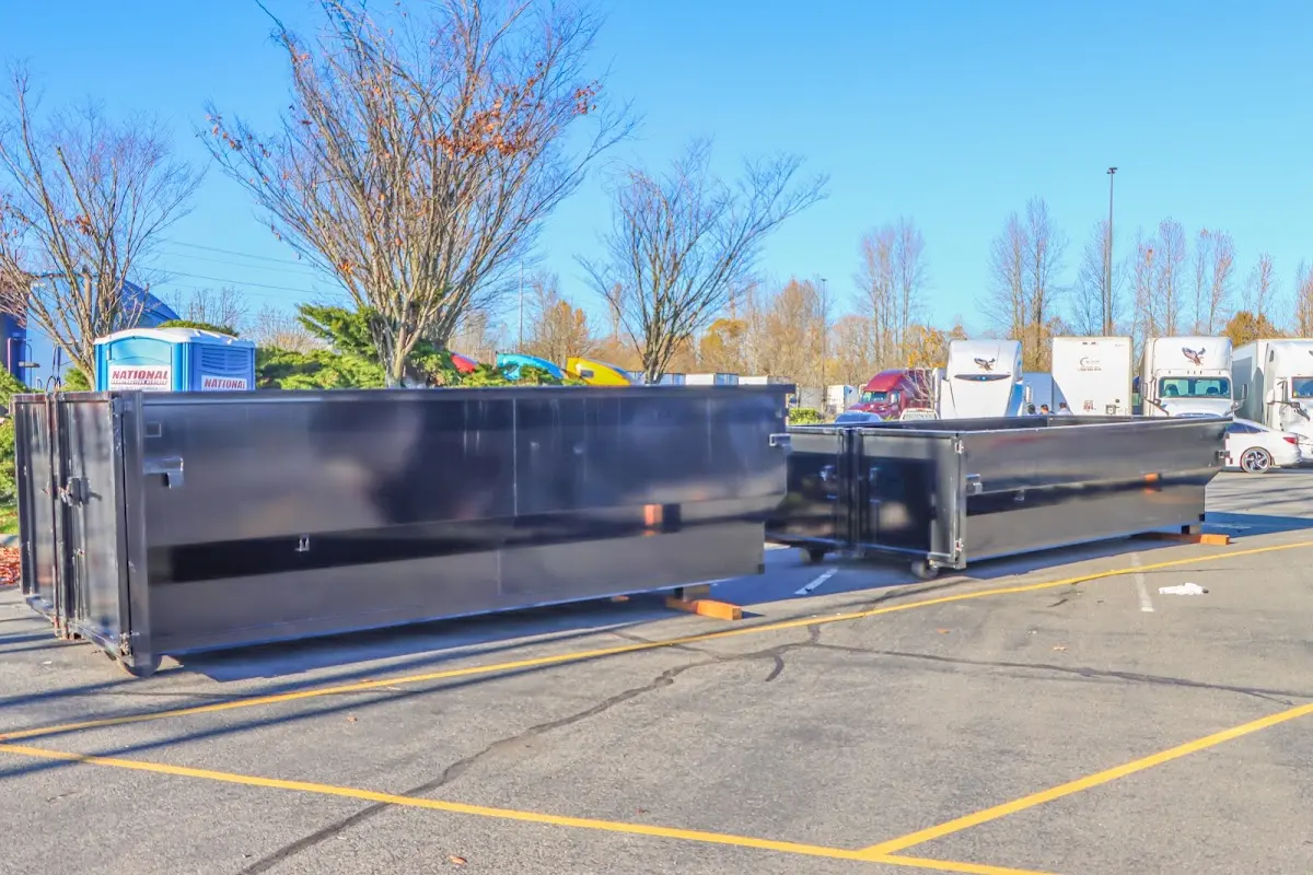 Professional dumpster rental service with roll-off container on residential driveway in Pismo Beach